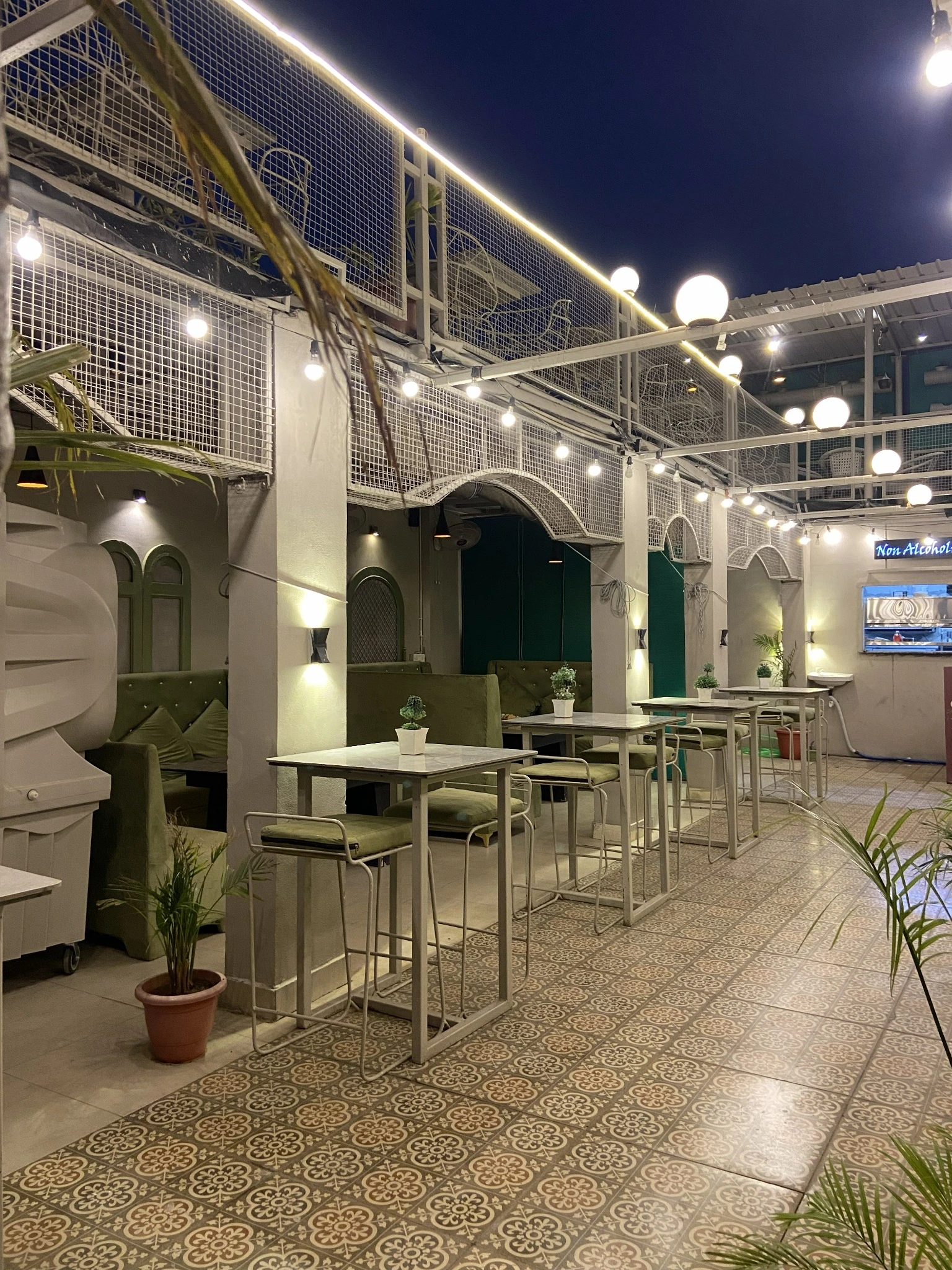 Club Clyrova rooftop dining passage with decorative lights and seating